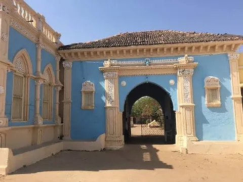 Blue-painted arched gateway of the darbargadh at Devpar