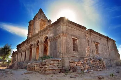 Ruined arched stone building at Roha under a bright sky
